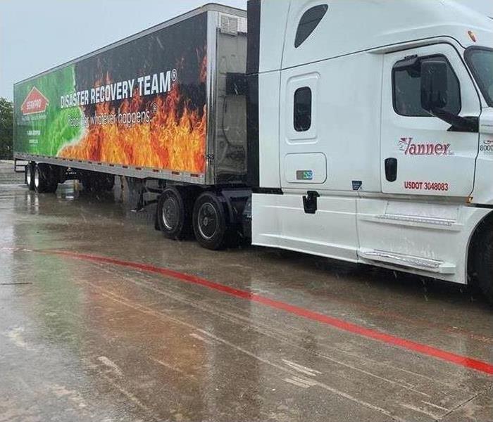 Trailer with lettering reading "SERVPRO Disaster Recovery Team" in the rain.