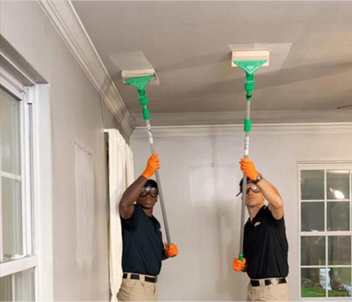 Two SERVPRO® experts work on a residential cleanup job.