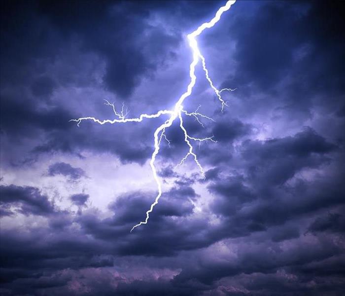 A bright lightning strike in a stormy sky