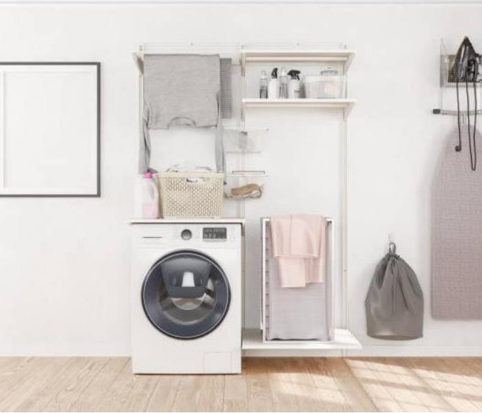 White modern-style laundry room with beige and gray accents.